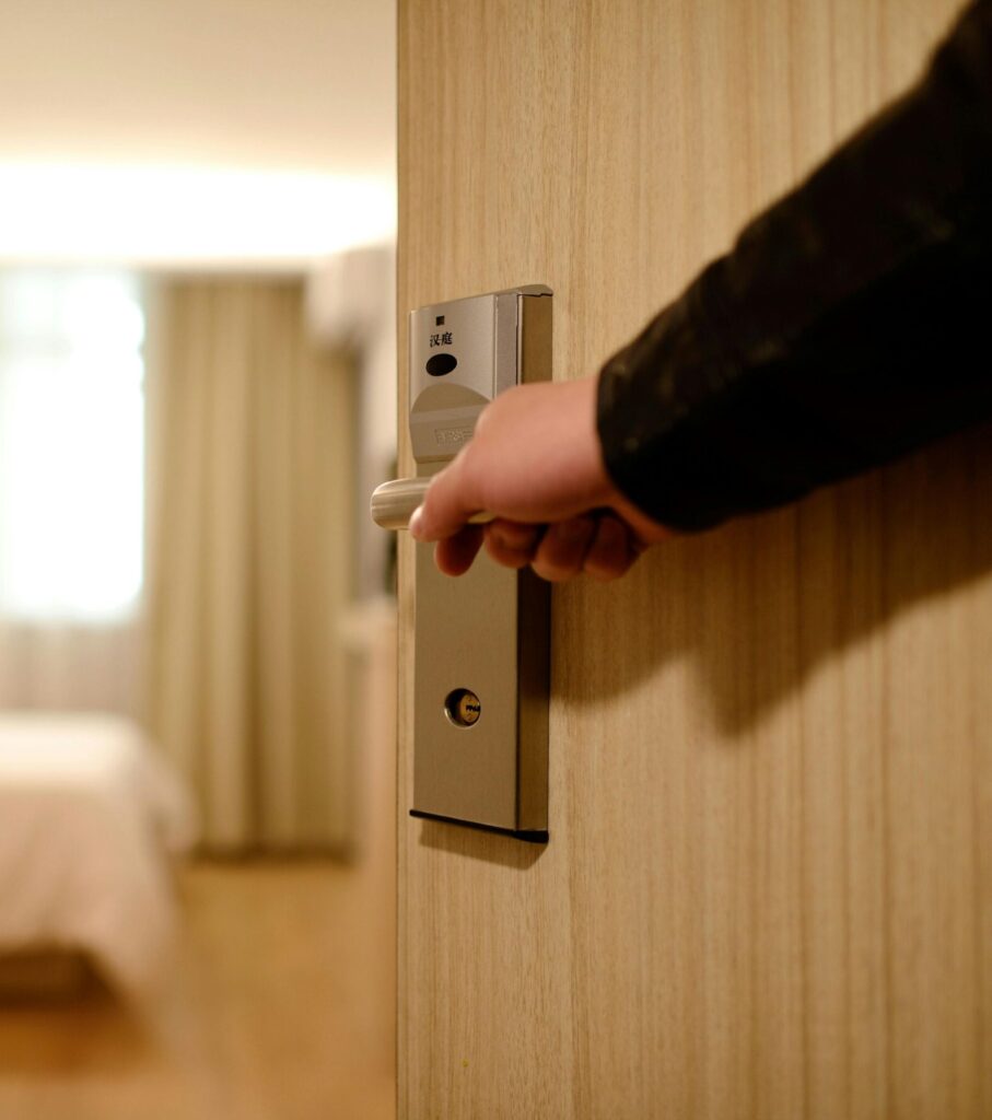 A soft-lit hotel room entrance, welcoming guests with luxury appeal and comfort.